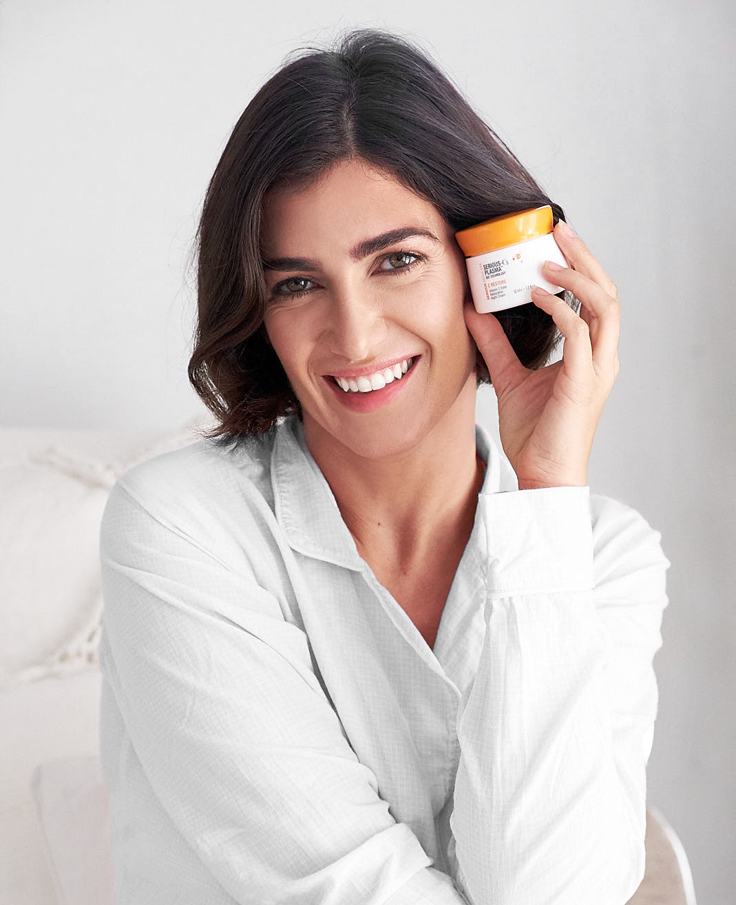 Female model enjoying the rejuvenating ingredients of the Serious C skincare line