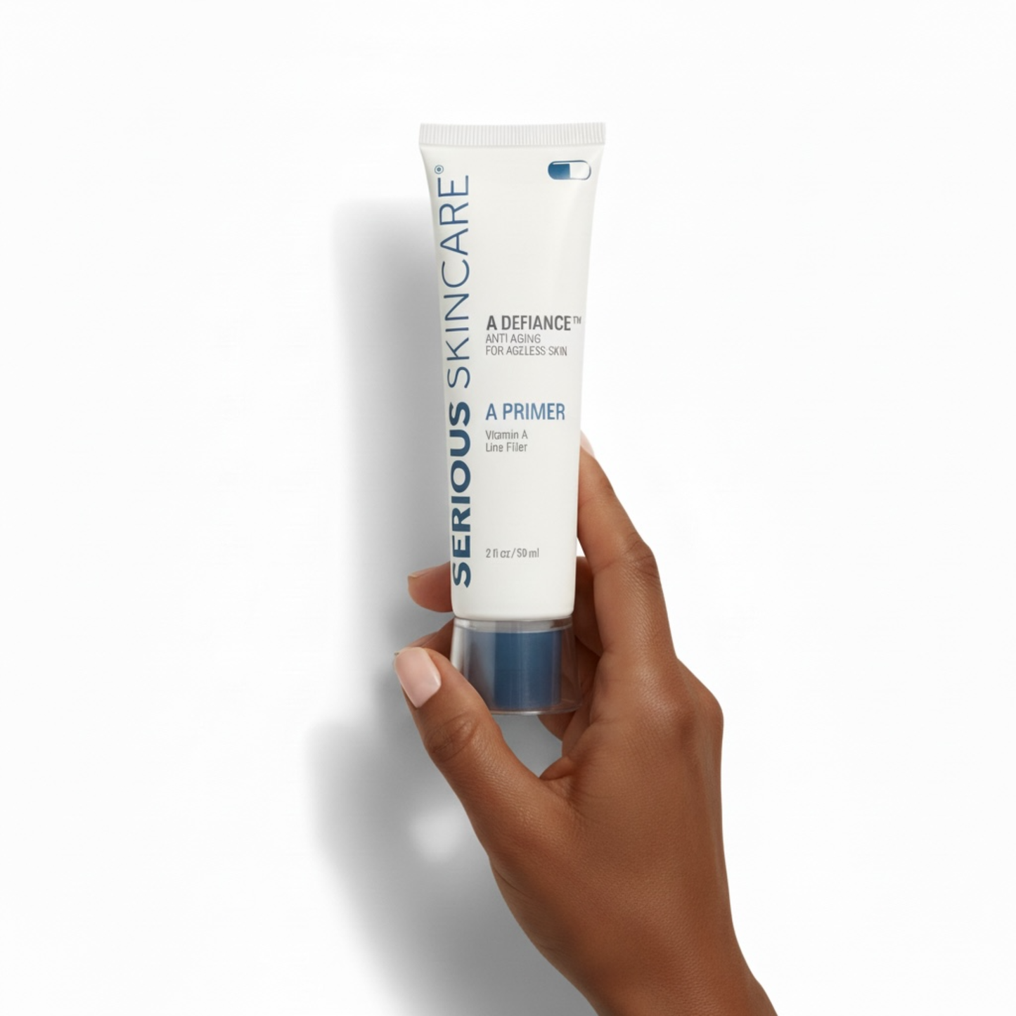 Hand holding a tube of Serious Skincare A Primer on a white background. Serious Skincare tube with product features on a beige background. Helps smooth visible wrinkles, visibly fills enlarged pores, blurs surface imperfections. Makeup glides on evenly - liquid or powder. Oil Free. Silicone Enhanced. Vitamin A Powered.