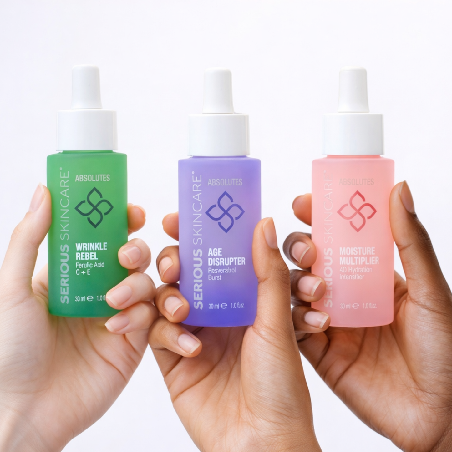 Three bottles of Serious Skincare Absolutes on a white background. Wrinkle Rebel. Ferulic Acid. Vitamin C + E. Age Disrupter. Resveratrol Burst. Moisture Multiplier. 4D Hydration Intensifier.