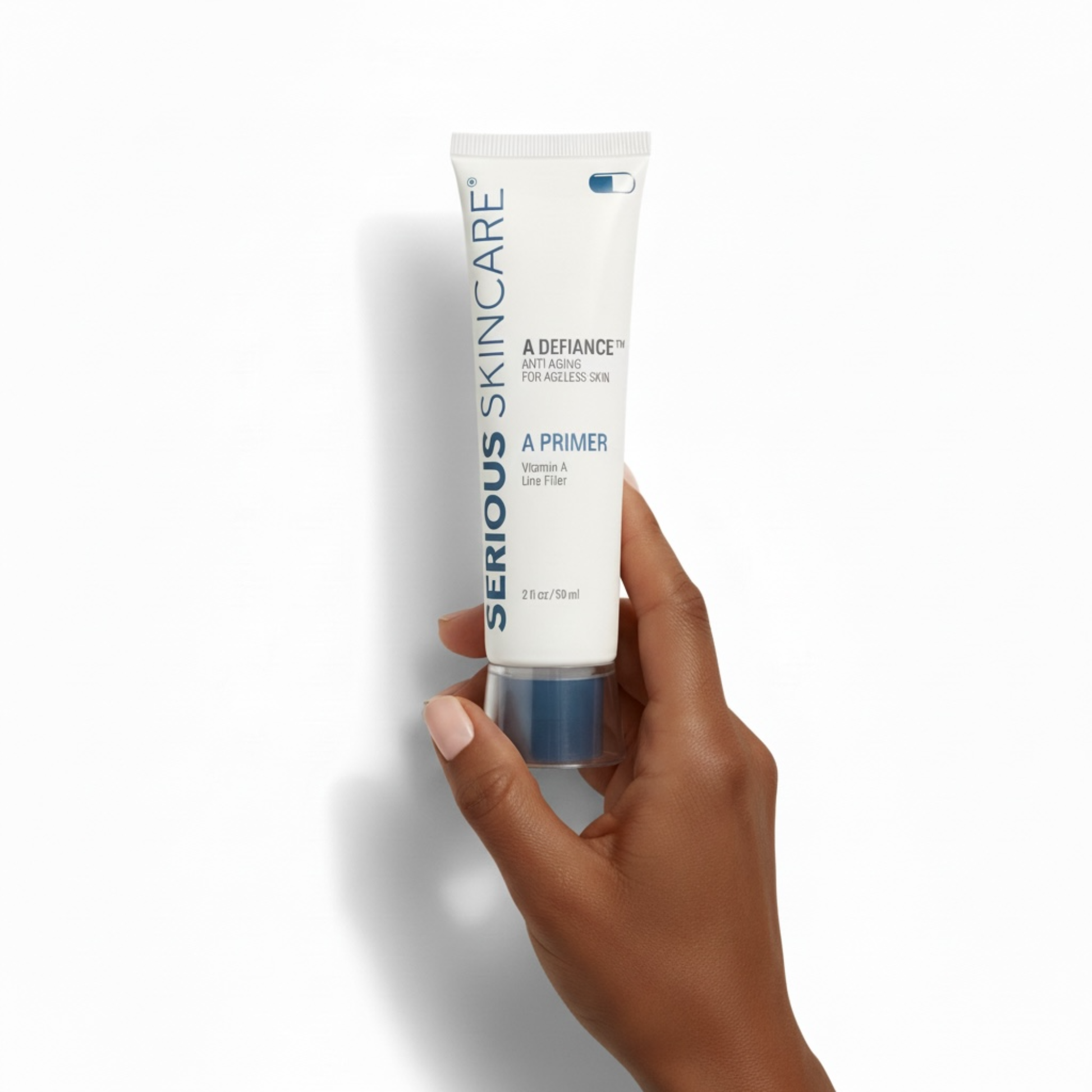 Hand holding a tube of Serious Skincare A Primer on a white background.  Serious Skincare tube with product features on a beige background.  Helps smooth visible wrinkles, visibly fills enlarged pores, blurs surface imperfections.  Makeup glides on evenly - liquid or powder.  Oil Free. Silicone Enhanced.  Vitamin A Powered.  