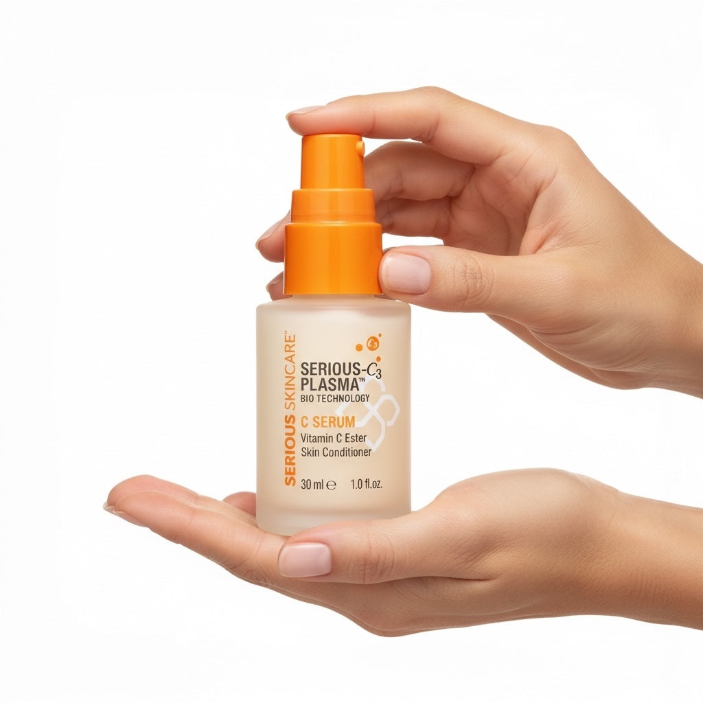 Hand holding a bottle of 'Serious Plasma' C Serum with an orange pump on a white background
