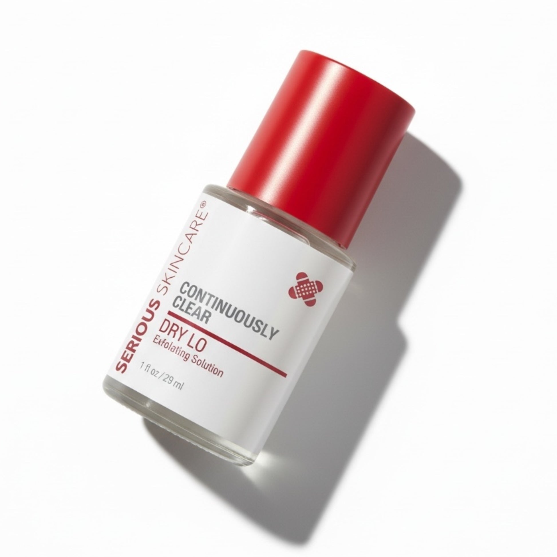 Skincare bottle with red cap on a white background. Dry Lo Exfoliating Solution