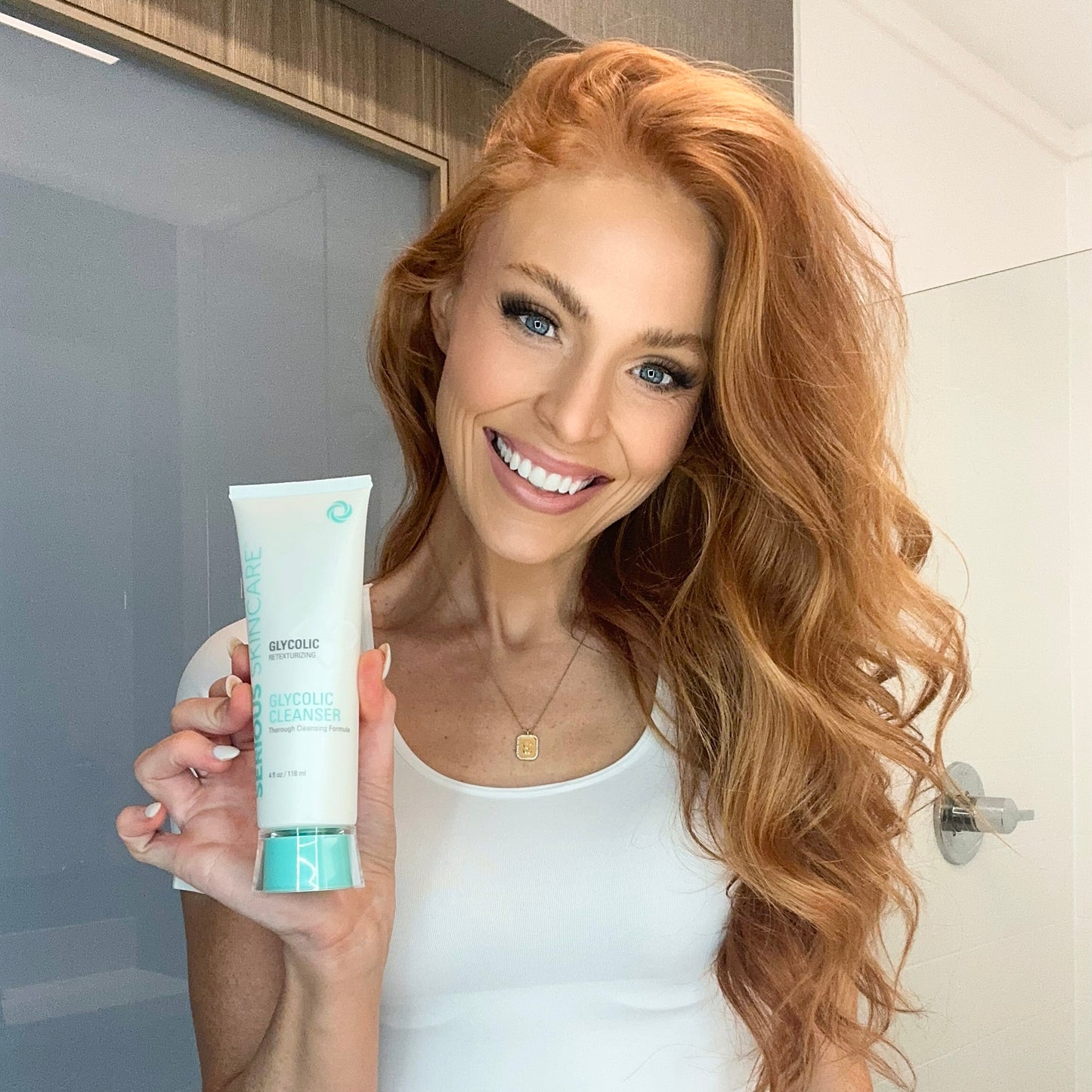 Model holdiing 4oz bottle of cleanser