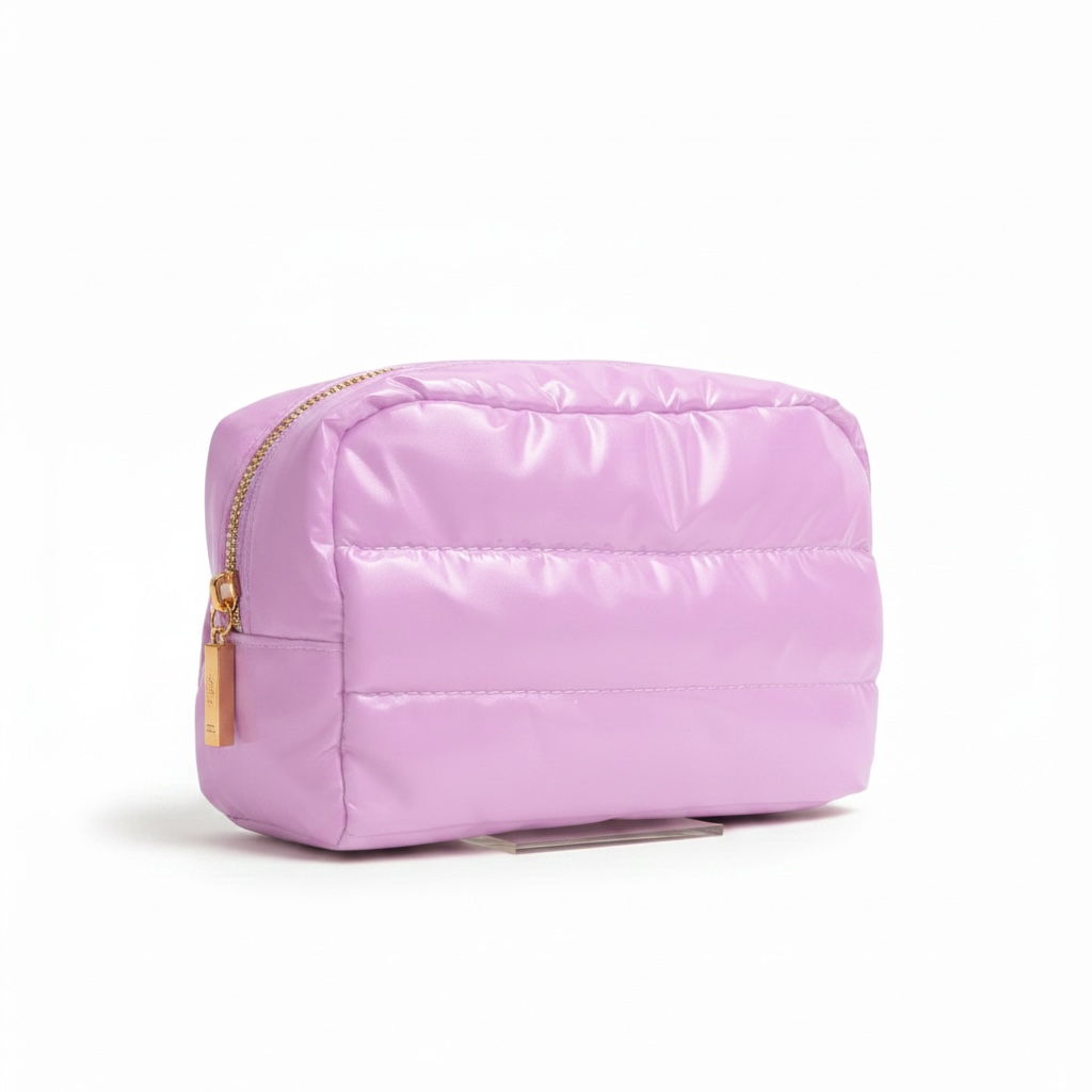 Pink quilted pouch with a gold zipper on a white background