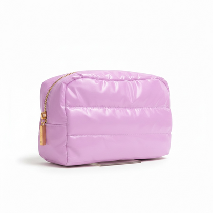 Pink quilted pouch with a gold zipper on a white background